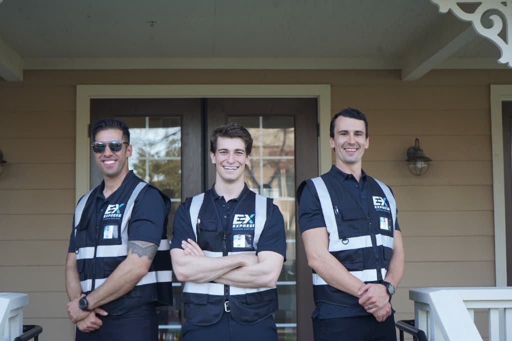 Three professional Express Courier Services drivers standing together in uniform